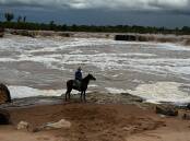 Burketown mayor and Gulf grazier Ernie Camp on Nutella looked over the Leichhardt Falls which are around 800m from the Floraville Station homestead. Picture: Supplied
