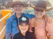 Kayla McIntyre taking Chelsea and Madalyn Collins out to the saleyards at Charters Towers. Picture: Contributed