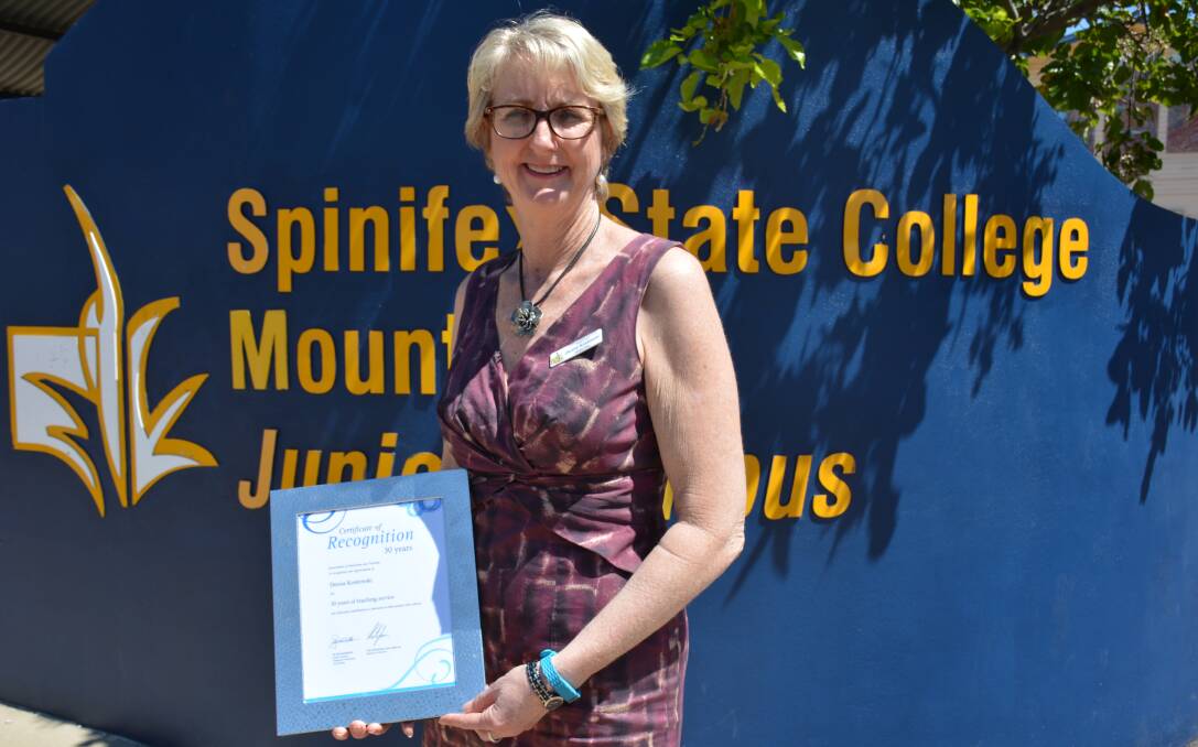 MILESTONE: Spinifex State College principal Denise Kostowski holds an award that recognises her 30 years working for Education Queensland. 28 years have been spent in Mount Isa. Photo: Chris Burns. 