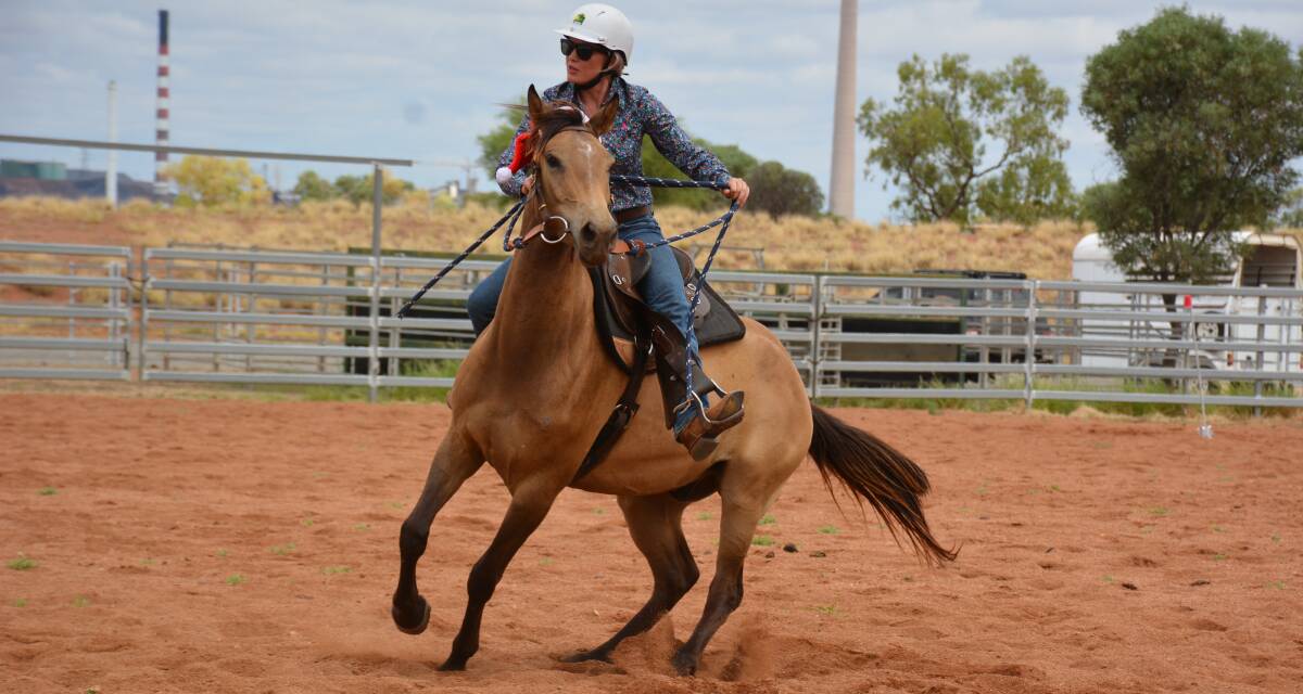 IN TRAINING: Sara Winn and Zephyr make a splendid turn while practising using a mechanical cow in the campdraft grounds. Photo: Chris Burns. 