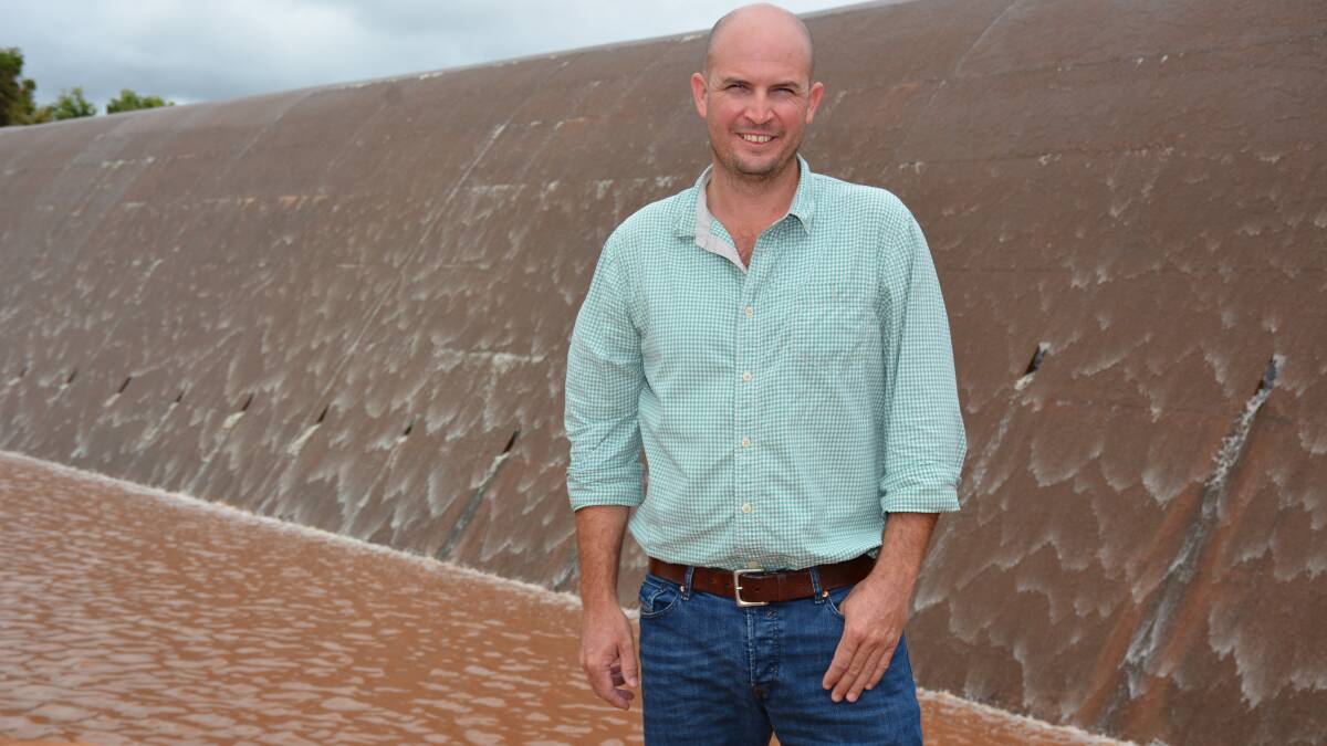 WALL OF WATER: Cloncurry mayor Greg Campbell is pleased to see water going over the spillway, but hopes more will come. Photo: Chris Burns. 
