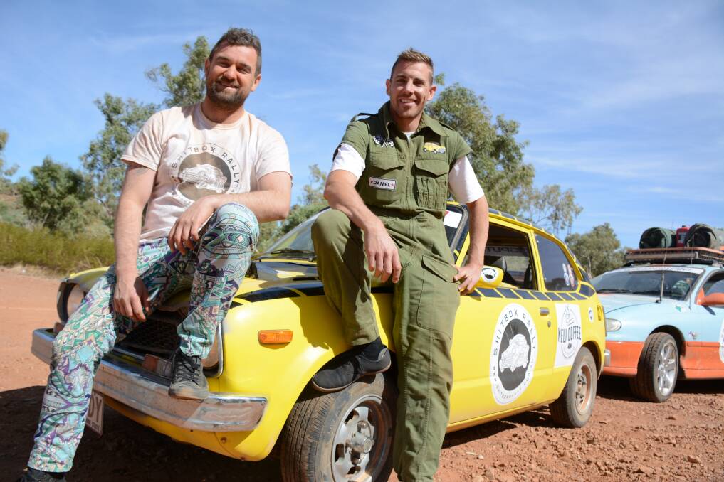 REST STOP: Craig McConaghy and Daniel Trani have had a rough journey in a 1976 yellow Honda Civic. They have just arrived in Mount Isa.  Photo: Chris Burns. 
