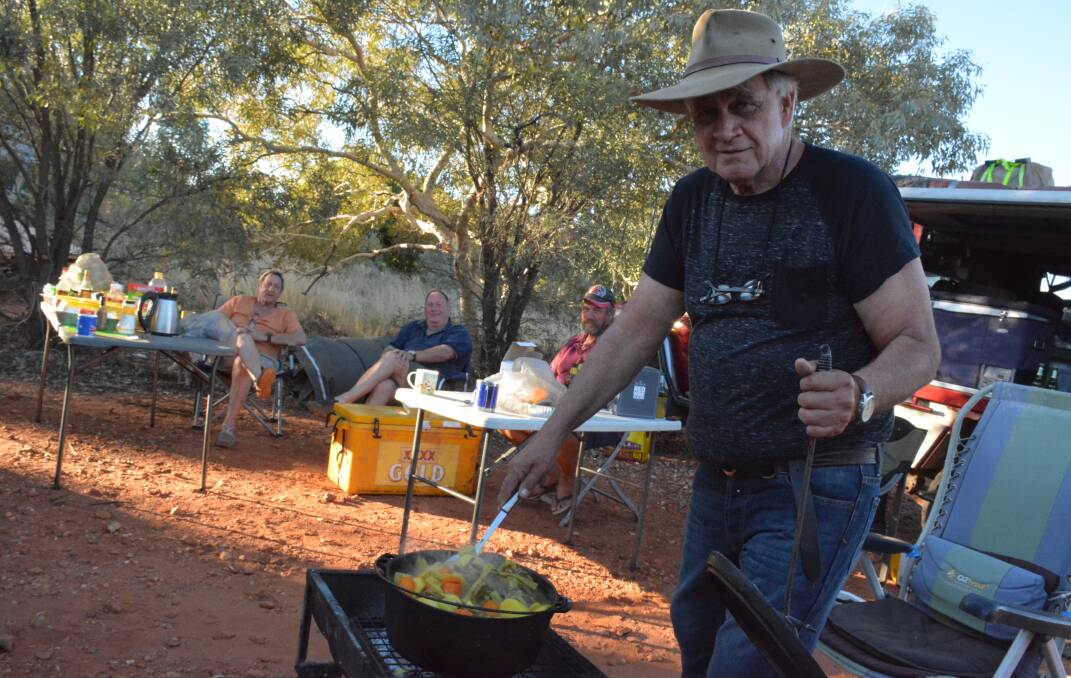 Fred Brophy stirs his lamb curry at his camp site. Photo: Chris Burns. 