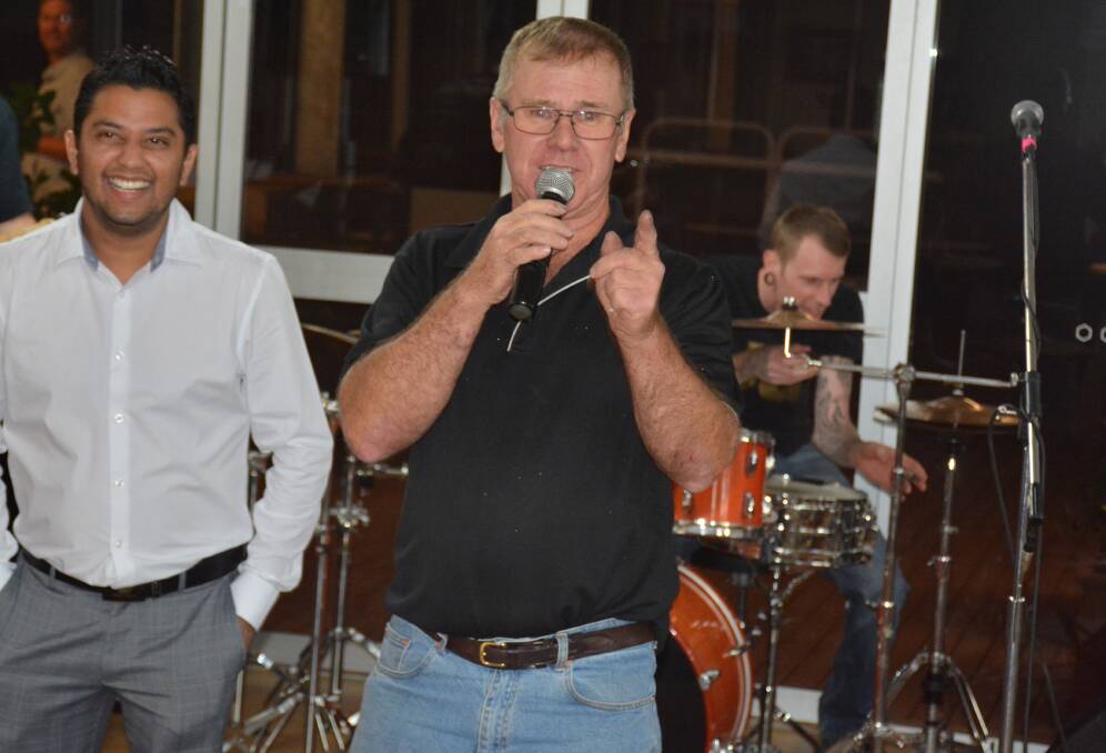 SPEECH TIME: Earl Kyle was cornered into making a farewell speech at a recent live music event in Mount Isa. He's pictured with businessman Vipul Gupta. 
