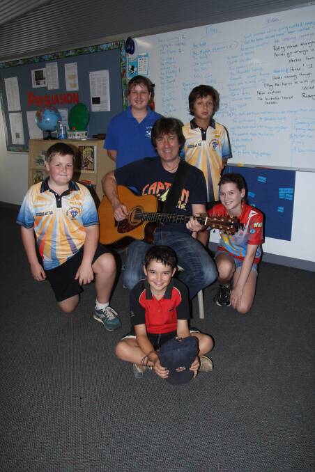 David Carter, Carter and Carter, with Gulf Savannah students who took part in the songwriting workshop, (back) Ella Heathwood, 11, and Zai Hopkins, (middle) Blayne Oliver, 11, and Bella Keough, 11, and Toby McDowall, 8, (front).