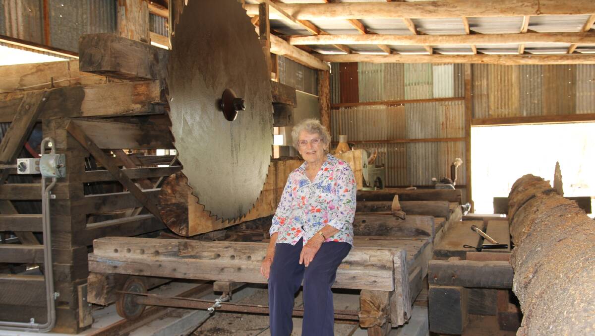 Phyllis Smith, of Herberton, beside a Canadian saw which features in the Keid's Saw and Planing Mill at the Historic Village Herberton.