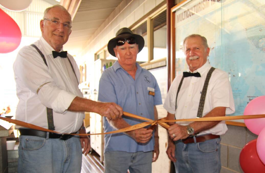 Volunteers Colin Cater, Pat Mason and Keith Wyer, Mareeba, cut the ribbon for the opening of Jamieson House at the heritage centre.