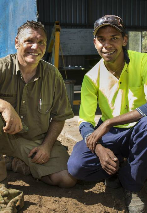Australian Army plumber and Indigenous liaison officer Corporal Terry Walker, left, mentors Kendall Bowen during the Army project in Laura.