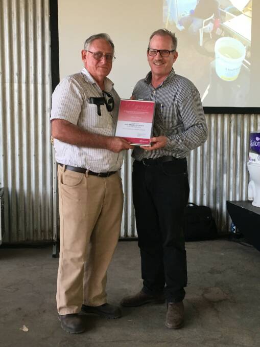 Senior beef extension officer Alan Laing is presented with his 50 years of service certificate by DAF science director for beef and sheep Bob Karfs.