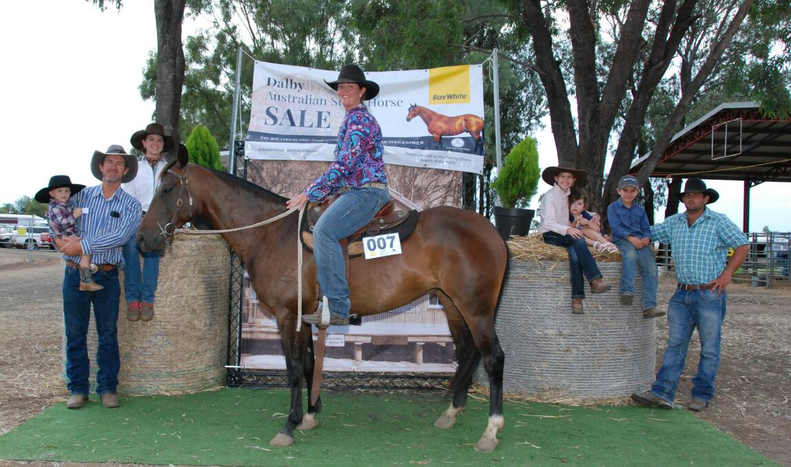 Kerrie Thompson riding Oneofakind Dixie Chic mare who topped the Dalby Australian Stock Horse Sale at $54,000 with buyer Andy Mulcahy (left), holding son Hugh Mulcahy and daughter Amy Mulcahy, Lily Mulcahy (right), Rose Habermann, Andy Mulcahy Jr and horse co-owner Zane Habermann.