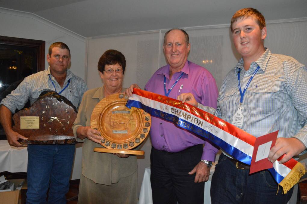 Dan Sullivan and Jan Cotter presenting the Charlie Cotter All Rounder Award to Doug and Hayden Pratt, Chatsworth at last year's Gympie Carcase Classic competition.