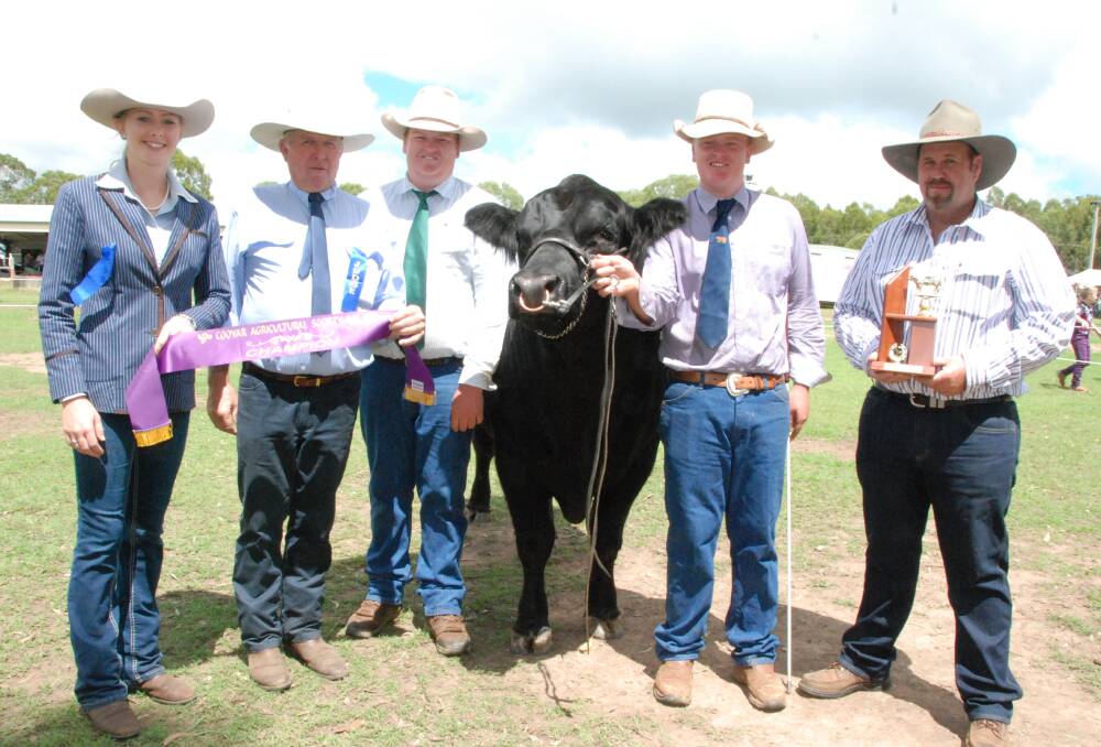 Grand Champion Bull of the Cooyar Show Jen-Daview Mr Pinnacle with judges Loretta Tonscheck and Gary Lindenmayer plus stud owners Brent and Corey Evans, Kingaroy and trophy presented by Wayne Schefe last Saturday.