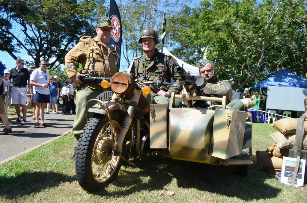 North Queensland Reenactors and Collectors members Bruce Horsten, Michael Formilan and Garry Luxford showcase the RT1 BMW Sidecar during the Townsville T150 Heritage Day held at West End Park on Sunday.