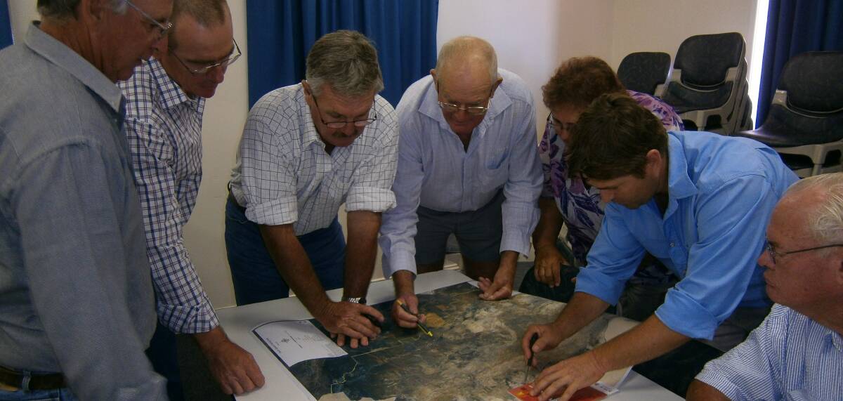 Brett Carlsson (second from left) and landholders working on a wild dog control program while identifying high priority areas at a landscape scale.