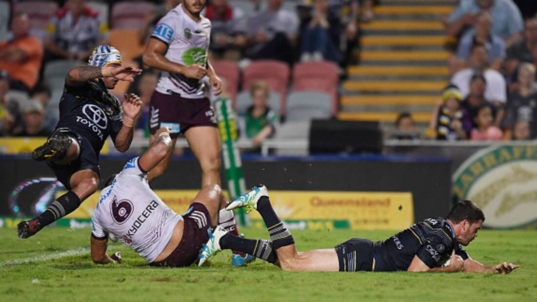 North Queensland Cowboys captain Johnathan Thurston looks on as teammate Lachlan Coote crosses the Manly tryline during the Cowboys 30-26 win over the Sea Eagles on Monday night in Townsville.
