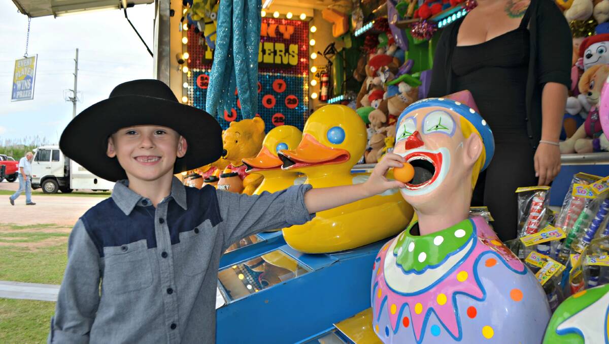 Ayr's Lincoln Bolam test his skills at one of the many sideshow alleys scattered around the Burdekin Showgrounds for this years show.