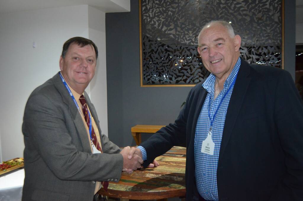 Newly appointed ALMA president Ken Timms is congratulated by outgoing president Steve Loane, who will remain on the ALMA board after the results of the associations Annual General meeting were announced on Thursday in Rockhampton.