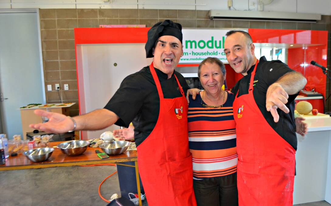 Viva l'Italia!: My Kitchen Rules celebrity chefs Martino and Luciano with fan Ada Capalano from Brisbane during one of the pairs cooking demonstration at the festival.