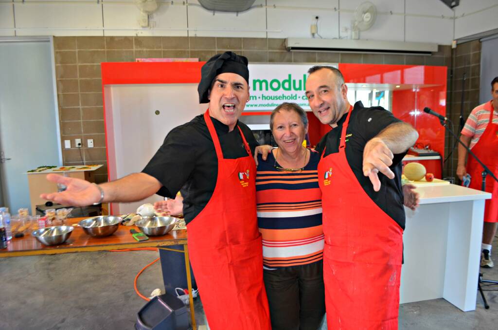 Viva l'Italia!: My Kitchen Rules celebrity chefs Martino and Luciano with fan Ada Capalano from Brisbane during one of the pair's cooking demonstrations at the festival.