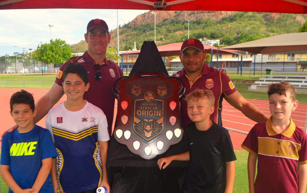 North Queensland Cowboys greats Brent Tate and Matt Bowen and fans Andrew Gatis, Jonathan Gatis, Jayden Robshaw and Dylan Lines gather around the coveted State of Origin shield at the Townsville Sports Reserve on Tuesday during Suncorp Bank's regional Origin shield tour. 