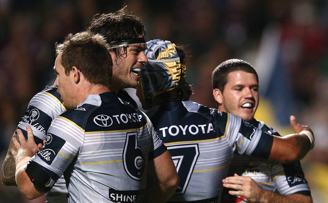 A clinical display: North Queensland Cowboys players celebrate after chalking up their fifth straight win with a dominant 34-18 victory against the outclassed Manly Sea Eagles at Brookvale Oval on Saturday night.