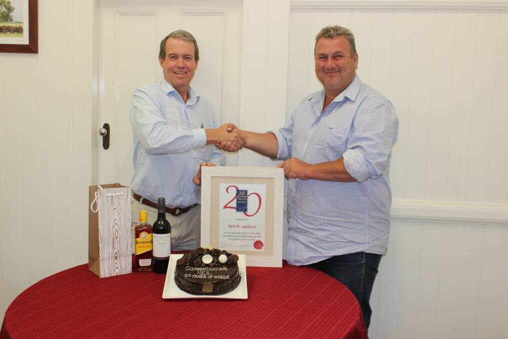 Droughtmaster Australia Society CEO, Neil Donaldson received a warm
congratulations from society president Paul Laycock, during a celebration for
Neil’s 20 years of service in the role of society operations manager and CEO.
Photo by Sharon Harms.