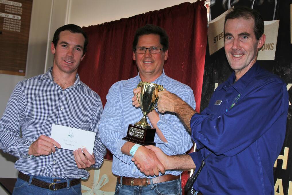 Westech steer trial convenor, Tom Chandler, and Mort and Co's Brett Campbell congratulate Bill Burton for his overall win in the Westech steer trial.