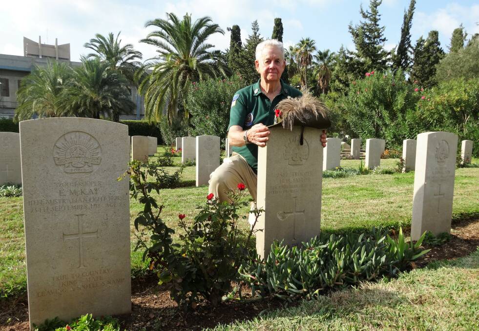 Austin Short at the grave of his grandfather, Howard Taylor, in Haifa, northern Israel.