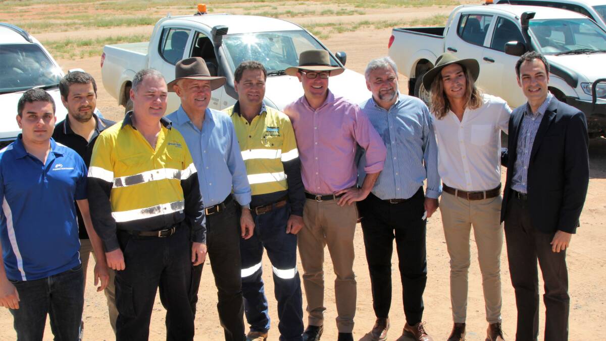 Group shot: Prime Minister Malcolm Turnbull (fourth left) and Maranoa MP David Littleproud (fourth right), pictured with Elecnor Australia staff, including executive director Joseph De Pedro, business development manager Manuel Lopez-Velez, and project manager Javier Alvarez, at the Barcaldine solar farm on Sunday. Pictures: Sally Cripps.