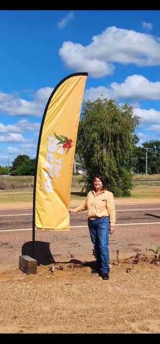 Yvonne Schaefer with the new highway sign for The Servo at Pentland. Picture: Supplied