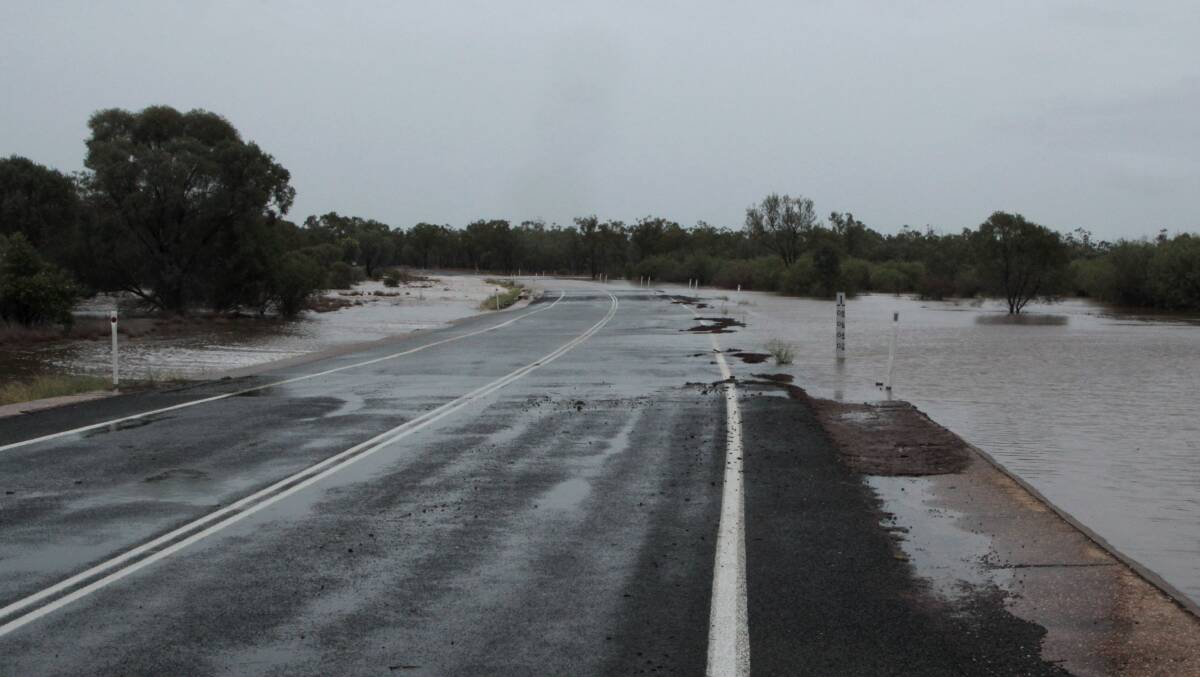 Floodway: A causeway on the Landsborough Highway 10km south of Barcaldine, overflowing with water after up to 150mm of rain upstream in the early hours of Sunday. Photo: Sally Cripps.