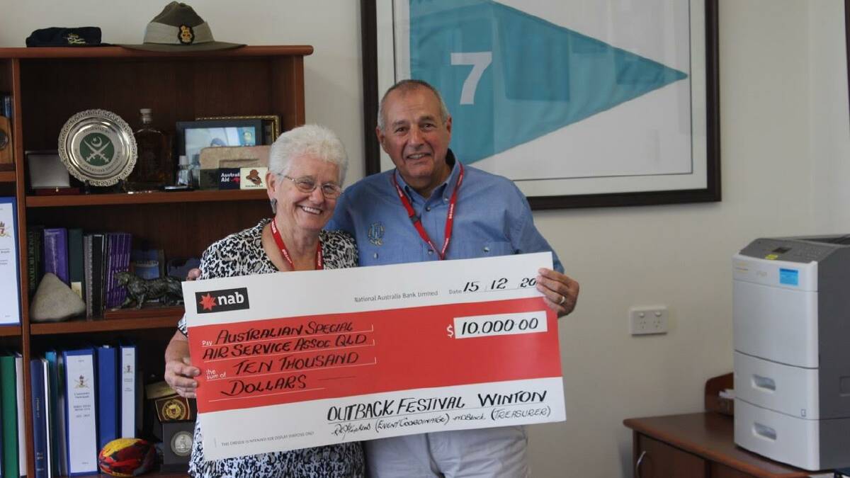 Outback Festival coordinator Robyn Stephens presenting one of three $10,000 cheques last week, to the Australian Special Air Services association.