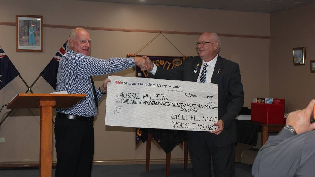 Big bucks: Townsville Castle Hill Lions Club members Brian McAtee and Phil Highland celebrate raising a million dollars for drought relief in Queensland. Picture: contributed.