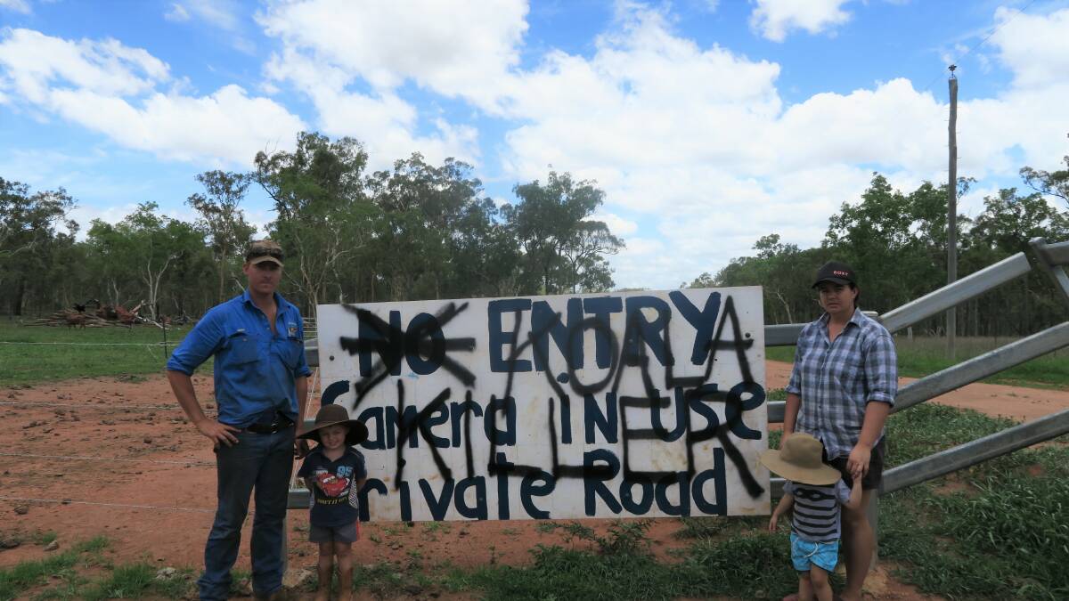 Dean and Emmalee Jonsson and their two children, William and Colby, with a sign on their property reading "Koala Killer". The sign was vandalised after ABC incorrectly reported the family were the subject of a federal investigation. 