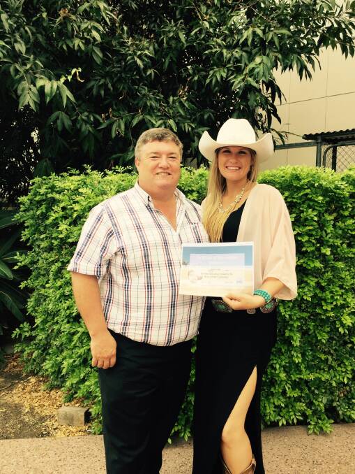 Katy Scott presenting the $3000 check to Charles Alder from Buy A Bale Foundation in Brisbane.