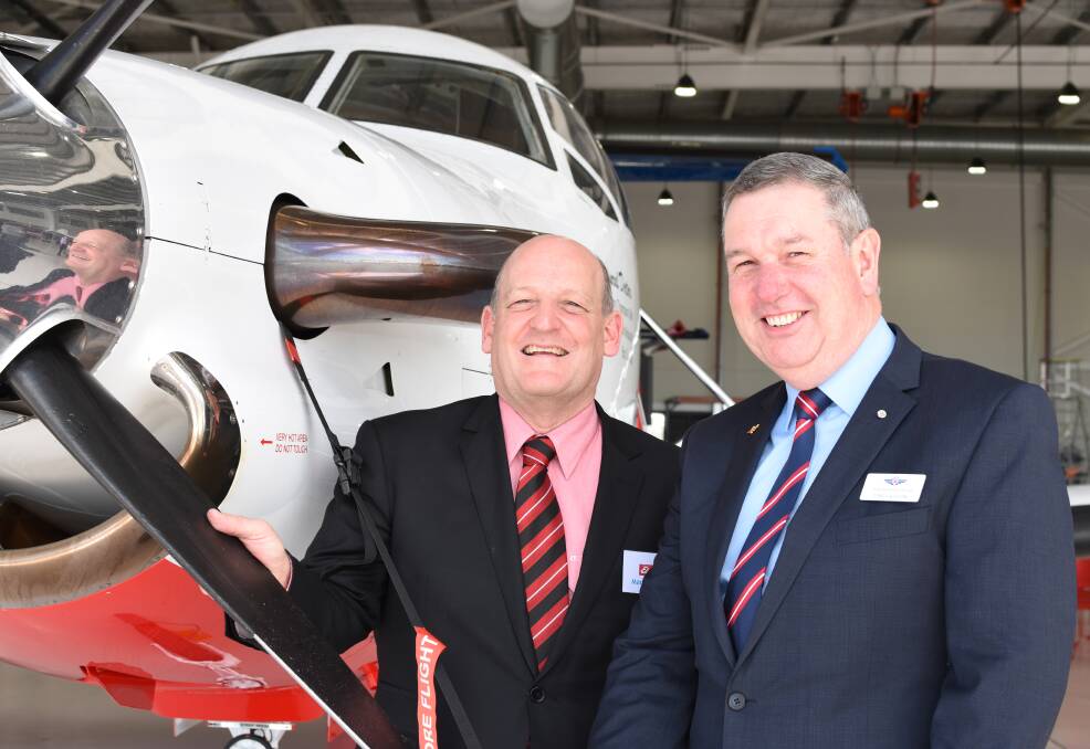 NEW BRANDING: Elders chief executive officer and managing director Mark Allison checks out RFDS aircraft "Whiskey" with deputy chief executive Tony Vaughan, which will carry the Elders logo for the next three years.