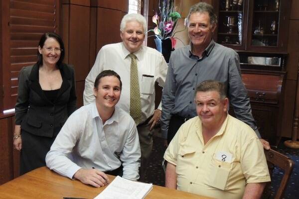 Karen McCallum (Vendor Representative). Brent Kinnane (Vendor), Bruce Smith (Ray White Auctioneer), Kevin Currie (Principal Ray White Rural Townsville) and John Glover (Buyer Representative) sign the paperwork for the sale of the 2598ha former Burdekin Agricultural College Farm and Campus which sold at auction for $5 million at Townsville Jupiters Casino yesterday.