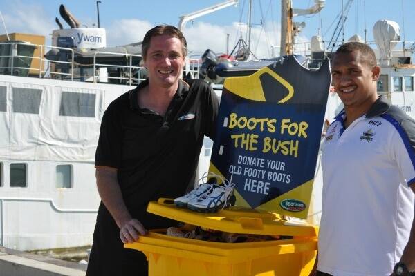 Brendon Day from Sportscene with Ray Thompson from the North Queensland Cowboys who was on hand to drop off the boots to take the number of pairs donated in the Boots for the Bush campaign to close to 1000.