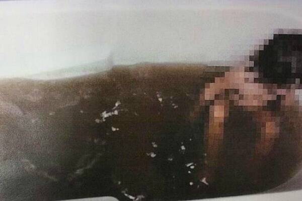 A picture tabled in parliament, of a child bathing in the dirty water from the Mount Isa electorate.