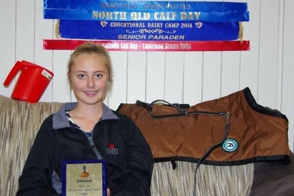 Rikki displays the trophy that she won as well as ribbons, a SEMEX jacket, a calf rug and halter and a calf feed measuring scoop and grooming gear.