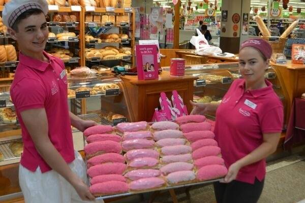 Logan Stanford and Elle Thompson of Bakers Delight at Stockland, Townsville, with a fresh tray of pink buns which the company is selling all over their locations in Australia with all proceeds going to the Breast Cancer Network Australia.