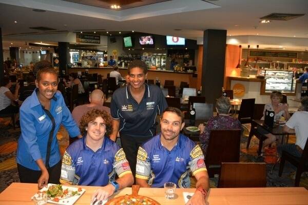 North Queensland Toyota Cowboys players Jake Granville and Hezron Murgha with Cowboys Leagues Club employee and Dream, Believe, Achieve program graduate Matilda Billy and current program participant Selina Zaro at Cowboys Leagues Club.