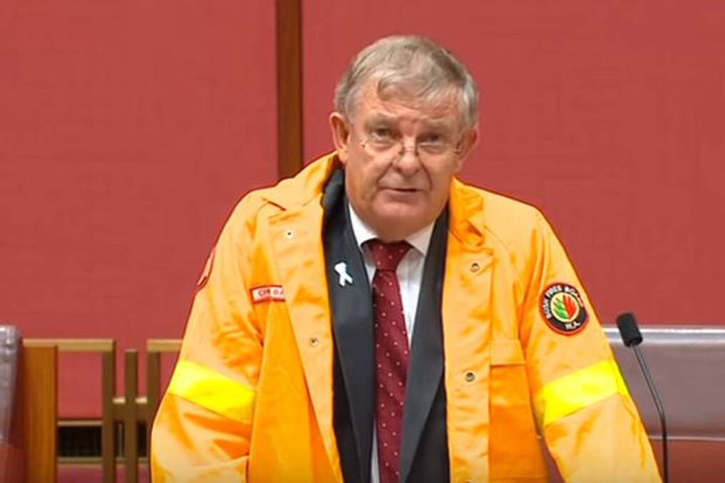 WA Liberal Senator Chris Back addresses the Senate yesterday in his Bush Fires Board of WA high-vis jacket. 
