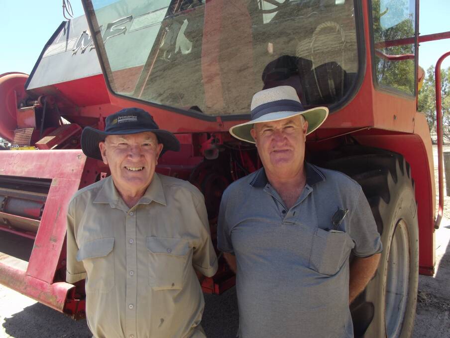 Quairading farmers Norm Marnham (left) and Clive Hawksley had a nostalgic look at the MF4500 header on offer. It later sold for $3500.