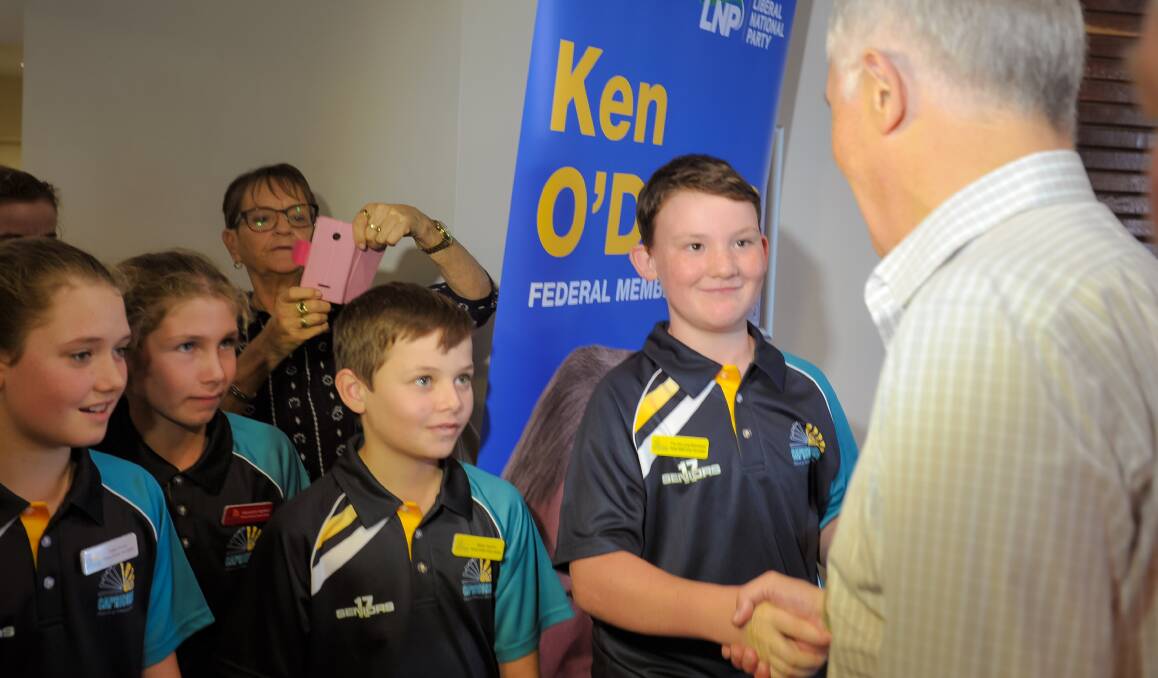 Capricornia School of Distance Education student Tim De Long-Marchand, Year 6, shakes hands with Prime Minister Malcolm Turnbull. 