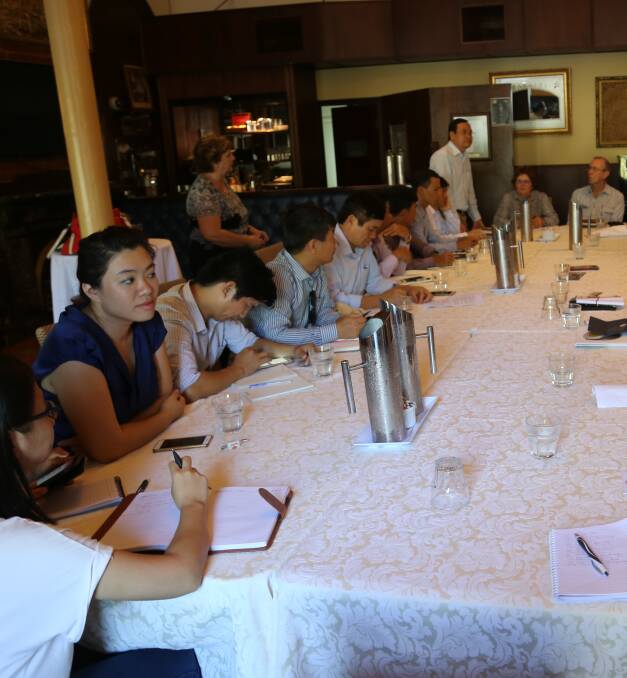 Vietnamese delegates discussing the beef industry with Australian representatives in Rockhampton on Monday. 