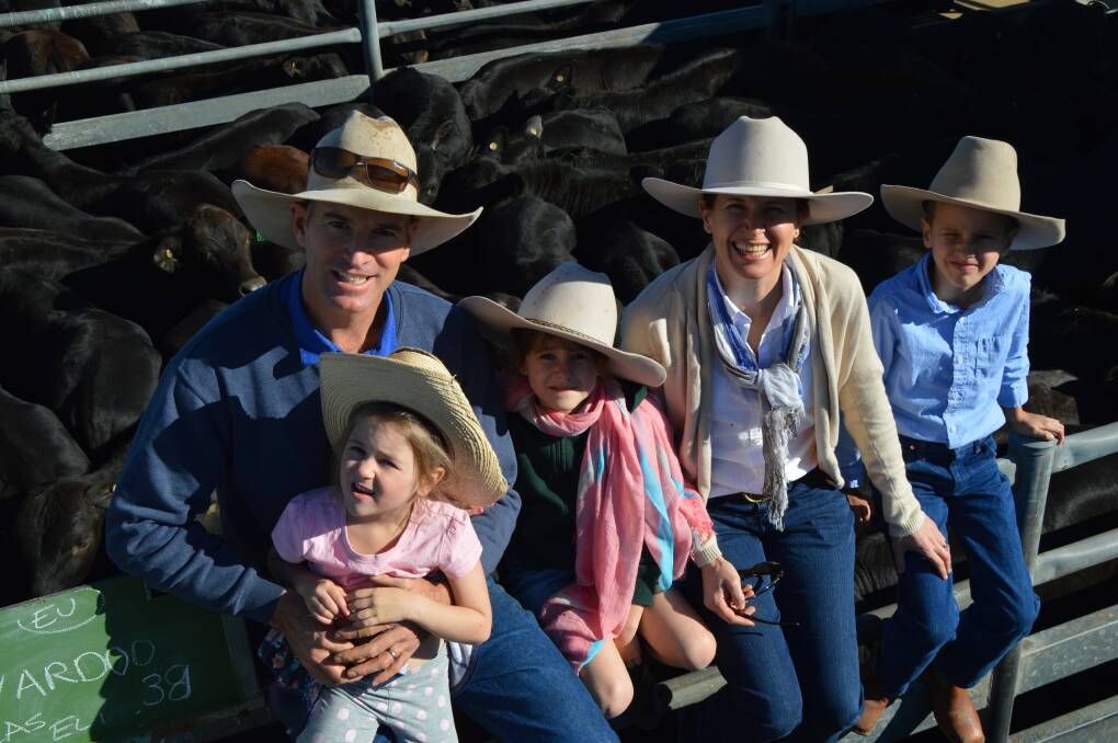 Flying colours: Cameron and Louisa Backus, Nardoo, Emerald, pictured with their children Poppy, Meg, and Angus, said catering to market demands was paying off in the saleyards.