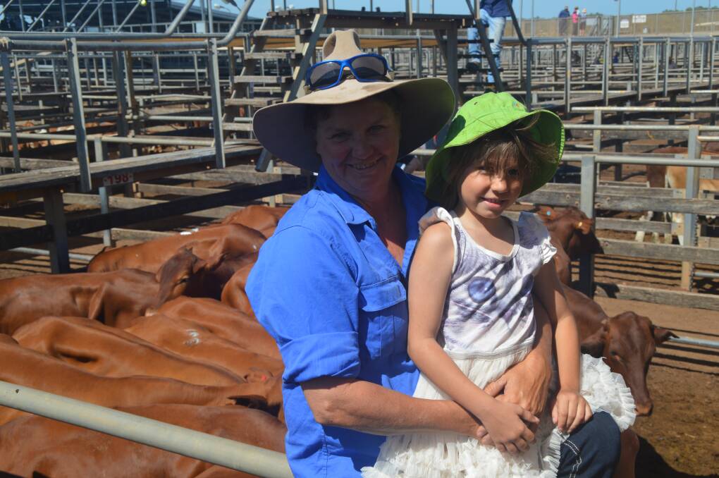 On track: Tammy Whitten, May Downs, Hughenden, and Lily Whitten, 6, were at the Roma store sale to watch their 109 steers and heifers sell after walking them from Hughenden.