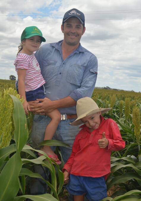 Fingers crossed: Stephen Gibson, Dulacca Farms, and his niece and nephew, Ella and Jack Bach, are hoping for one more fall of rain before harvesting the October planted sorghum.