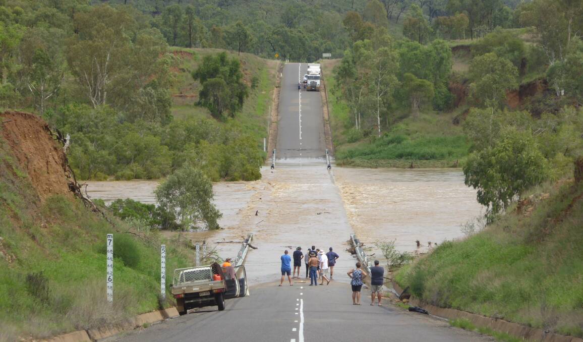 INUNDATED: Floodwater stops traffic on the Gregory Highway near Mount Fox Road, about 150km north of Charters Towers. Photo: Adam Christie.